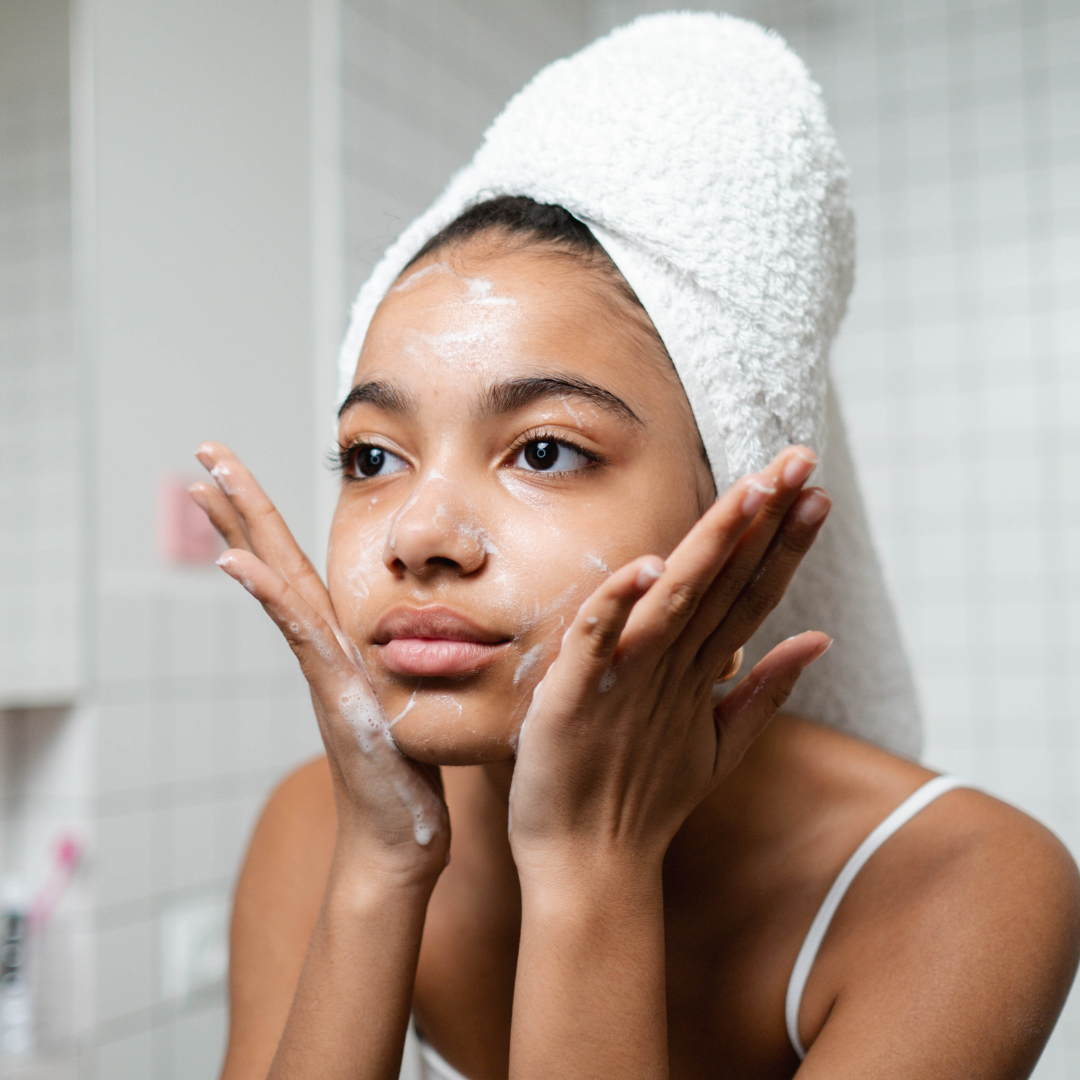 Girl cleansing face